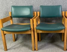 A pair of mid century light oak lounge armchairs in faux leather upholstery. H.80 W.57 D.51cm (