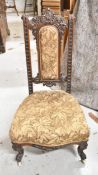 A Victorian carved mahogany nursing chair.