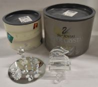 A boxed set of three Swarovski crystal animal figures and a similar grand piano.