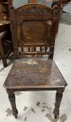 A 19th century carved oak hall chair.