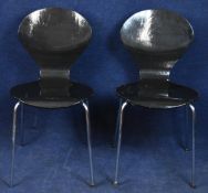 A pair of painted and laminated Arne Jacobsen style chairs.