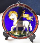 A vintage stained glass Lamb and Flag leaded circular panel. W.25cm