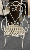 A vintage wrought metal and painted garden or conservatory armchair.