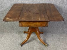 A Regency mahogany drop flap Pembroke table on pedestal base. H.71 W.48 (91 extended) D.91cm