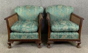 A pair of early 20th century mahogany framed bergère armchairs on carved ball and claw cabriole