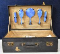 A 19th century vanity case and five piece guilloche enamel dressing set with hallmarked silver