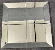 A contemporary wall mirror with glazed frame. (In four sections). H.80 W.80cm
