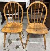 A pair mid century elm and beech Windsor stick back dining chairs.