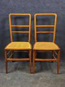 A pair of Edwardian mahogany and satinwood inlaid bedroom chairs.