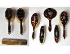 A 19th century tortoiseshell five piece dressing set with silver inlay and frames, hallmarked
