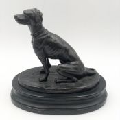 A spelter figure of a seated dog. H.23 W.24cm.