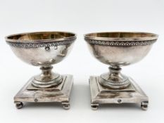 A pair of 19th century continental silver salt cellars on pedestal stepped bases. H.7cm. Weight