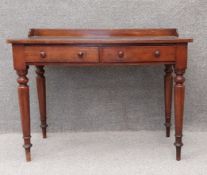 A mid 19th century mahogany writing table with tooled leather inset top above frieze drawers on