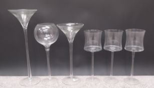 A collection of six glass florists vases, all in the form of large wine and other drinks glasses.