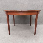 A mid century teak G-Plan extending dining table fitted with integral butterfly leaf. H.73 Dia.122