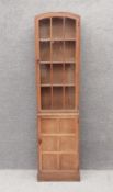 A vintage oak narrow bookcase with glazed and panel doors enclosing full height bookshelves. H.179