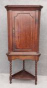 A Georgian oak and mahogany crossbanded corner cupboard on stand. H.168 W.76 D.44cm