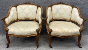 A pair of French 19th century Rococo carved walnut armchairs in damask upholstery. H.77 W.75 D.55cm