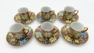 A collection of six Chinese Huiyuan porcelain coffee cans and saucers hand painted with mille