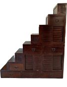 An Eastern teak two section chest cabinet in the form of full height steps. H.202 W.182.5 D.55cm