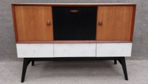 A contemporary Lucy Turner sideboard in teak and formica with lazer-cut palm tree decoration, having