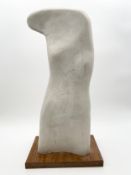 An abstract plaster figurative study of a female nude on a veneered plinth. H.49cm.