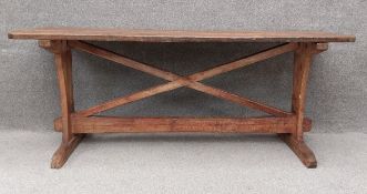 A 19th century pitch pine refectory style dining table on X stretchered trestle supports. H.74 W.183