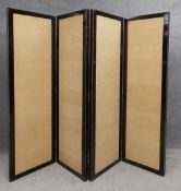 A large contemporary Eastern lacquered screen or room divider with four panels. H.183 W.50cm each