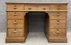 A 19th century pitch pine pedestal desk with an arrangement of nine drawers on a plinth base. H.78