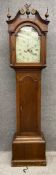 A 19th century oak long case clock on a moulded pedestal base below a long trunk door. With eight