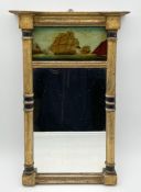A 19th century gilt and ebonised Regency pier mirror with a breakfront cornice above a reverse