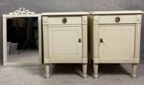 A pair of contemporary French style bedside tables with brass handles, the cabinet doors being