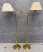 A pair of vintage style brass standard reading lamps with articulated extending arms. H.146 W.