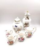A collection of porcelain with hand painted floral and gilt decoration to include two lidded urns