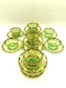 A set of ten hand blown, hand painted and gilded Bohemian style green glass dessert bowls with