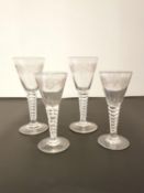 A set of four possibly Georgian hand blown glasses with etched grape and vine decoration, on facet-