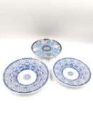 Three pieces of blue and white porcelain with similar scrolling patterns, to include a footed