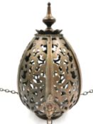 A pierced bronze hanging lantern with three mounted winged cherubs heads. H.31cm