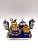 A matched set of 19th century porcelain miniatures with a royal blue glaze and gilt and hand painted