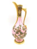A 19th century porcelain ewer of classical form with hand painted and gilt vine and grape decoration