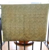 A pale green linen backed textile wall hanging with embroidered Arabic text, possibly verses from