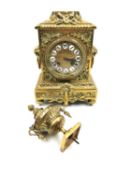 A French 19th century brass mantel clock with an embossed dial bearing Roman numerals and allover