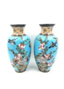 A pair of 19th century Japanese Meiji cloisonné vases of baluster form, with continuous designs of