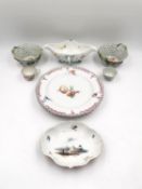 A Meissen lobed dish with a central hand painted rural scene surrounded by floral decoration and a