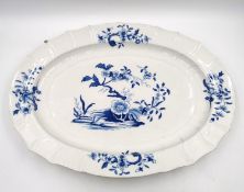 An 18th Century blue and white Tournai platter, with flowers and rockwork decoration surrounded by
