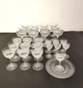 A collection of cut glass to include twelve champagne coupes, nine sherry and seven liqueur glasses,