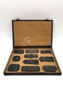 A Chinese calligraphy stone ink block set circa 1900, intricately carved in relief with gilt