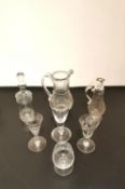 A collection of Georgian and later hand blown glass to include two decanters and a jug, and four
