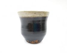 Bernard Howell Leach (1887-1979), a stoneware tea bowl in a dark tenmoku glaze with a speckled
