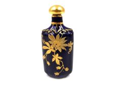 A Royal Worcester miniature porcelain bottle with a rich blue glazed ground with applied and gilt